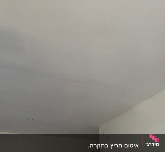תקרה פנימית עם כתמי רטיבות ותיקון צבע לאחר נזק איטום